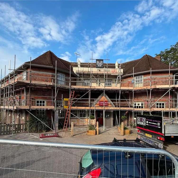 Commercial scaffolding installed around a pub building for safe access during refurbishment works